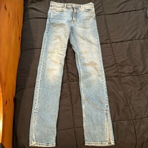 Split hem blue jeans